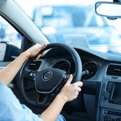 woman-sitting-new-car-car-salon-holding-steering-wheel